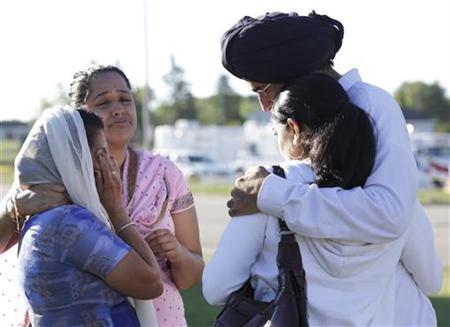 Mourners cry outside the scene of a mass shooting in Oak Creek, Wisconsin