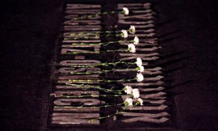 Auschwitz plaque with flowers in Yad Vashem Holocaust memorial on Holocaust Remembrance Day